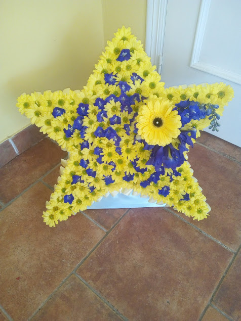 Blue and yellow star funeral tribute
