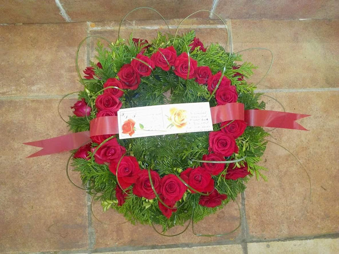 ring of red roses funeral tribute
