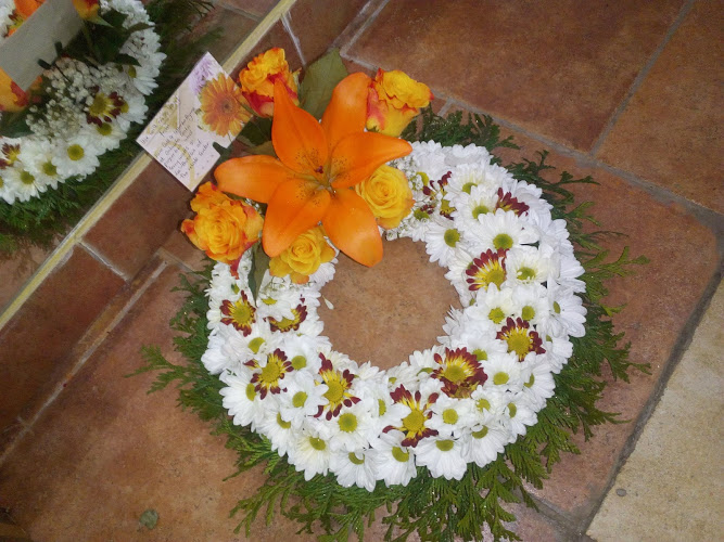 white and orange funeral wreath
